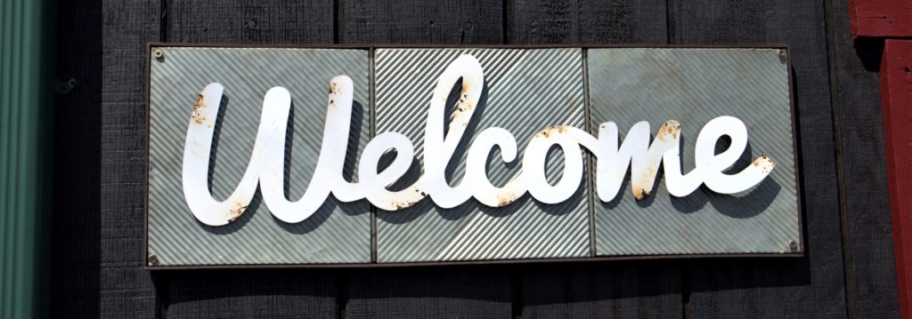 Wooden sign saying "welcome"